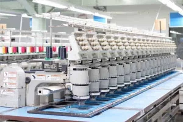 Skilled embroidery technicians applying custom logos