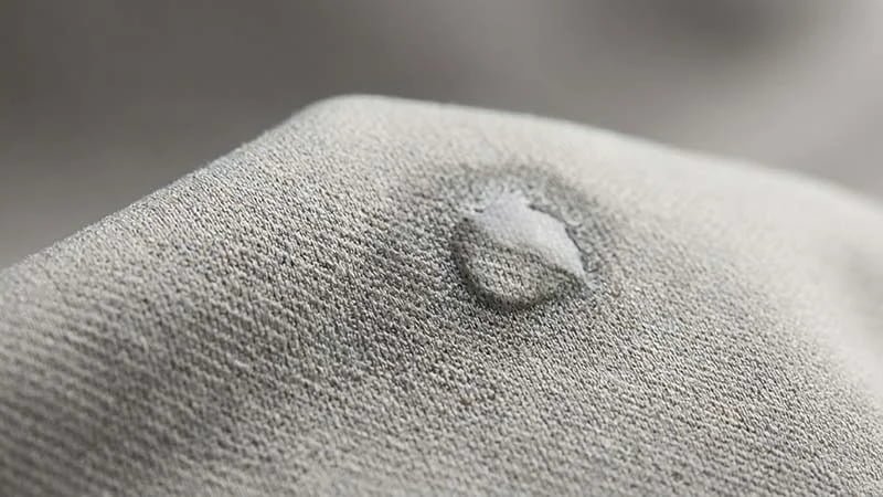 A close-up of a high-performance, moisture-wicking golf fabric.