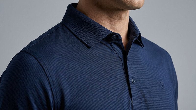 Details of a quality golf polo A close-up shot of a high-quality polo shirt showing the fabric texture and a structured collar