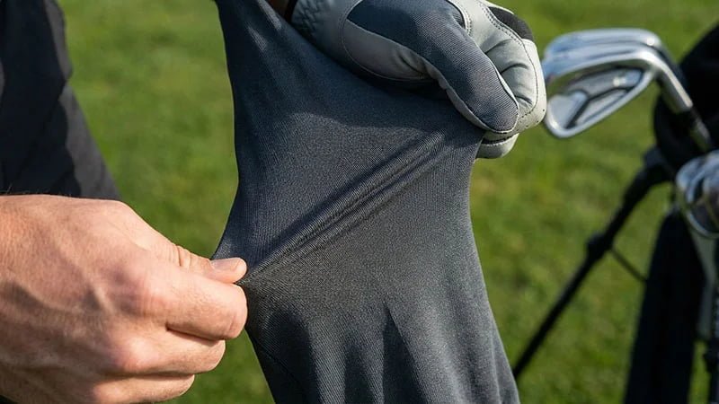 A close-up of a 4-way stretch fabric being pulled to show its elasticity.