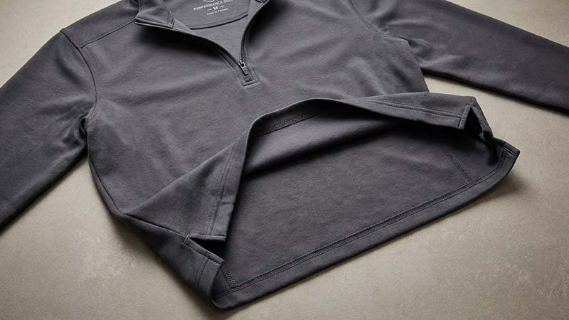 An inside-out view of a quarter-zip showing flatlock seams.