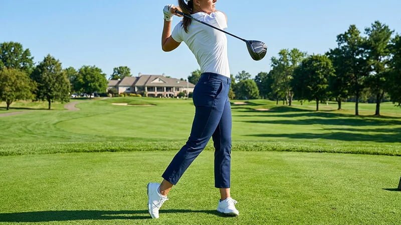 A female golfer in stylish, well-fitting ankle-crop golf pants