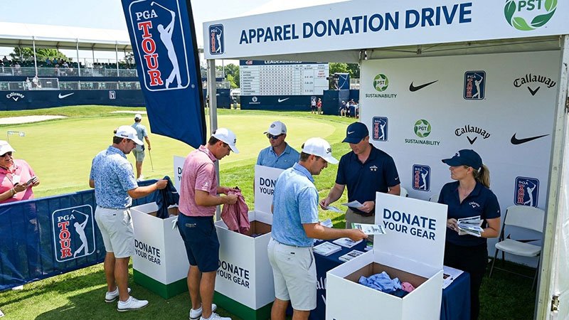 Sustainability initiatives at a golf tournament A booth at a golf tournament with signs for an apparel donation drive